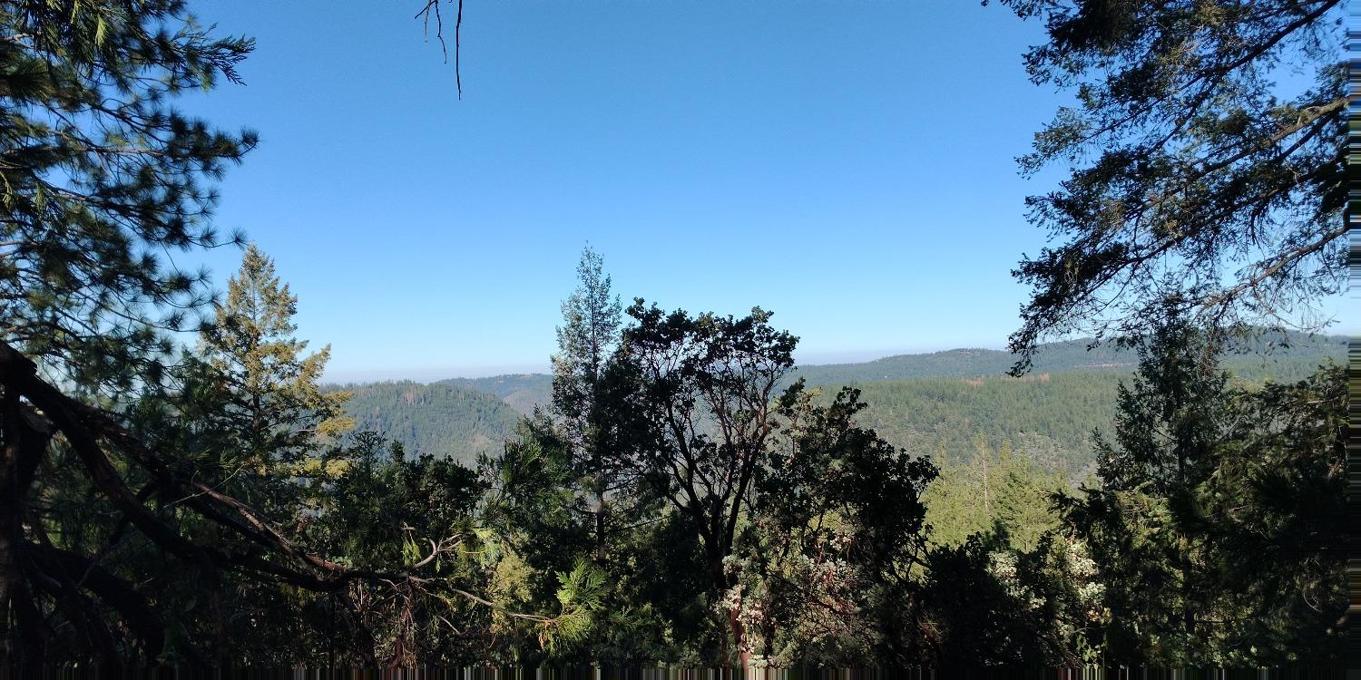 a view of a lake in between two and trees