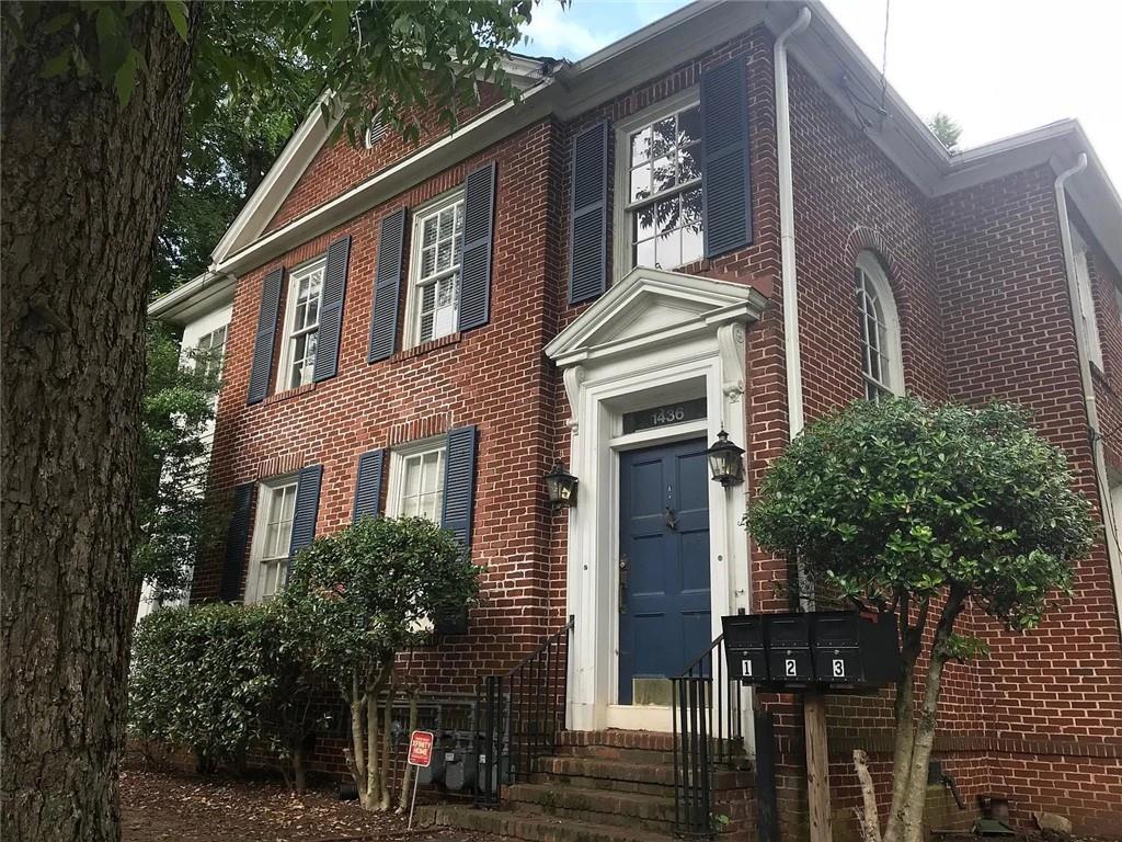 a front view of a house with tree s