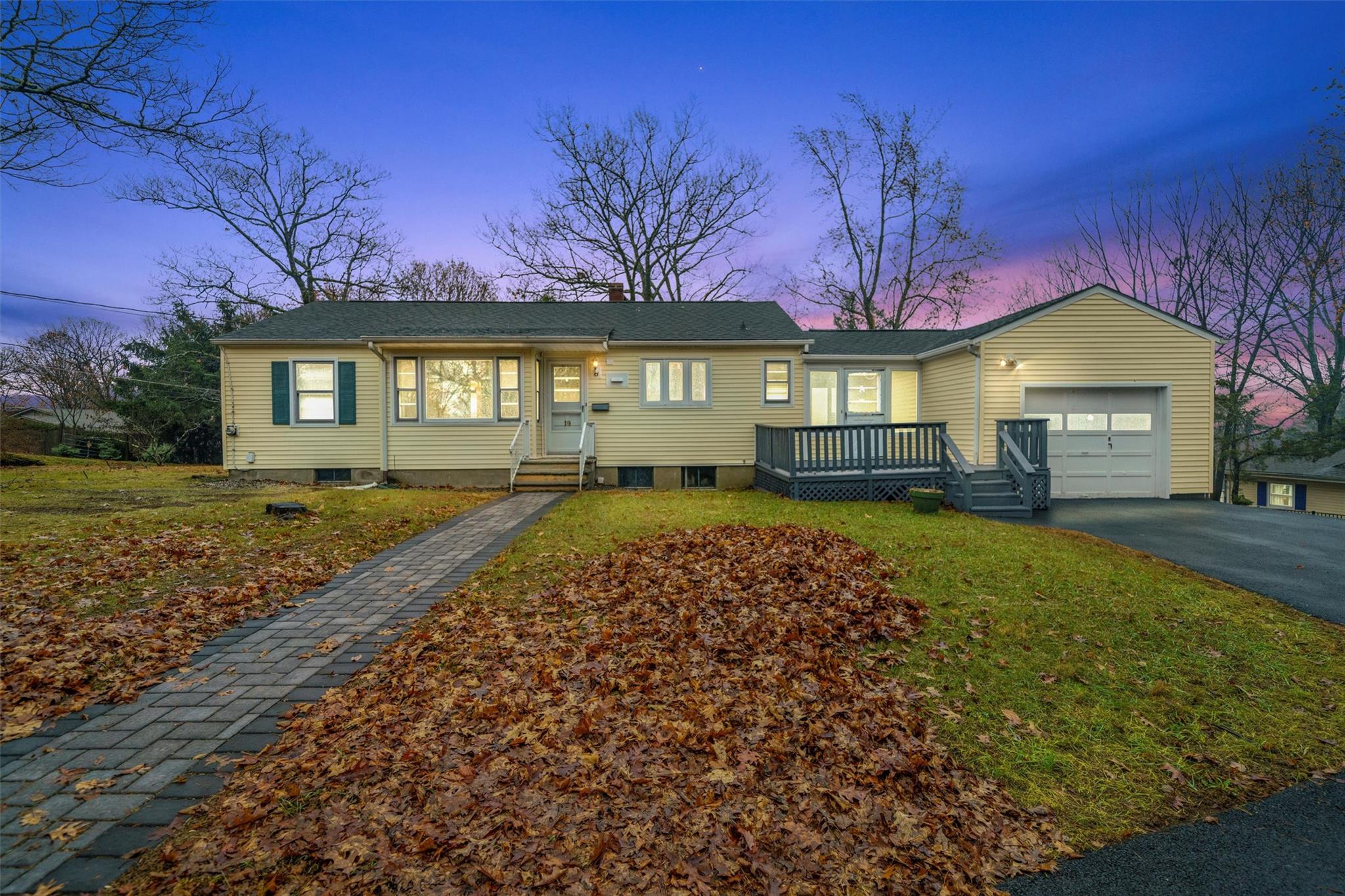 Ranch-style house with a yard and a garage