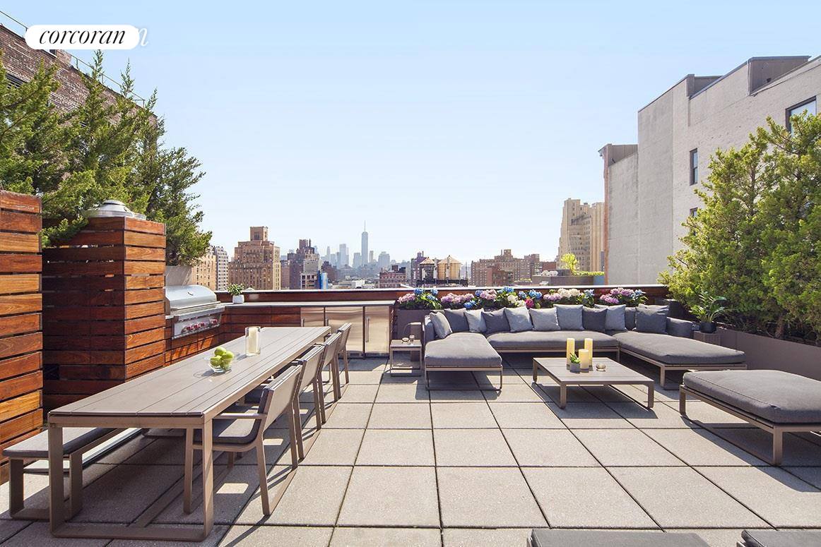 a terrace with outdoor seating and city view