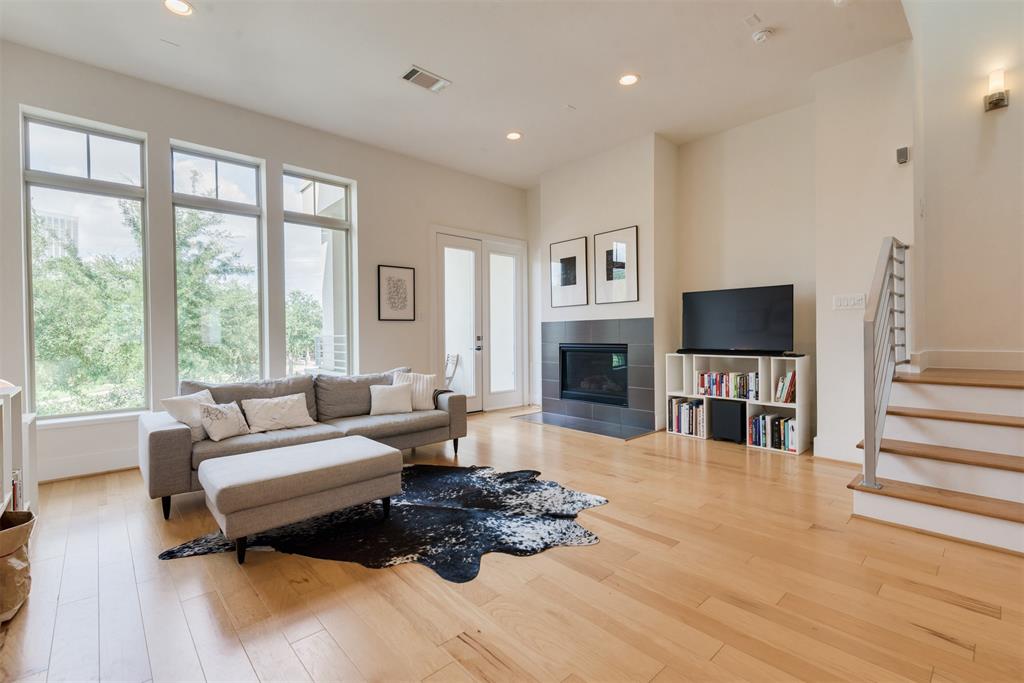 a living room with furniture flat screen tv and a fireplace