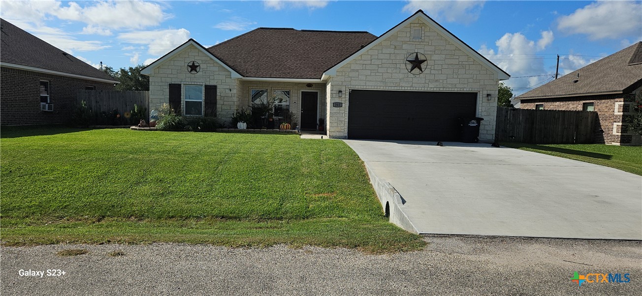 a front view of a house with garden