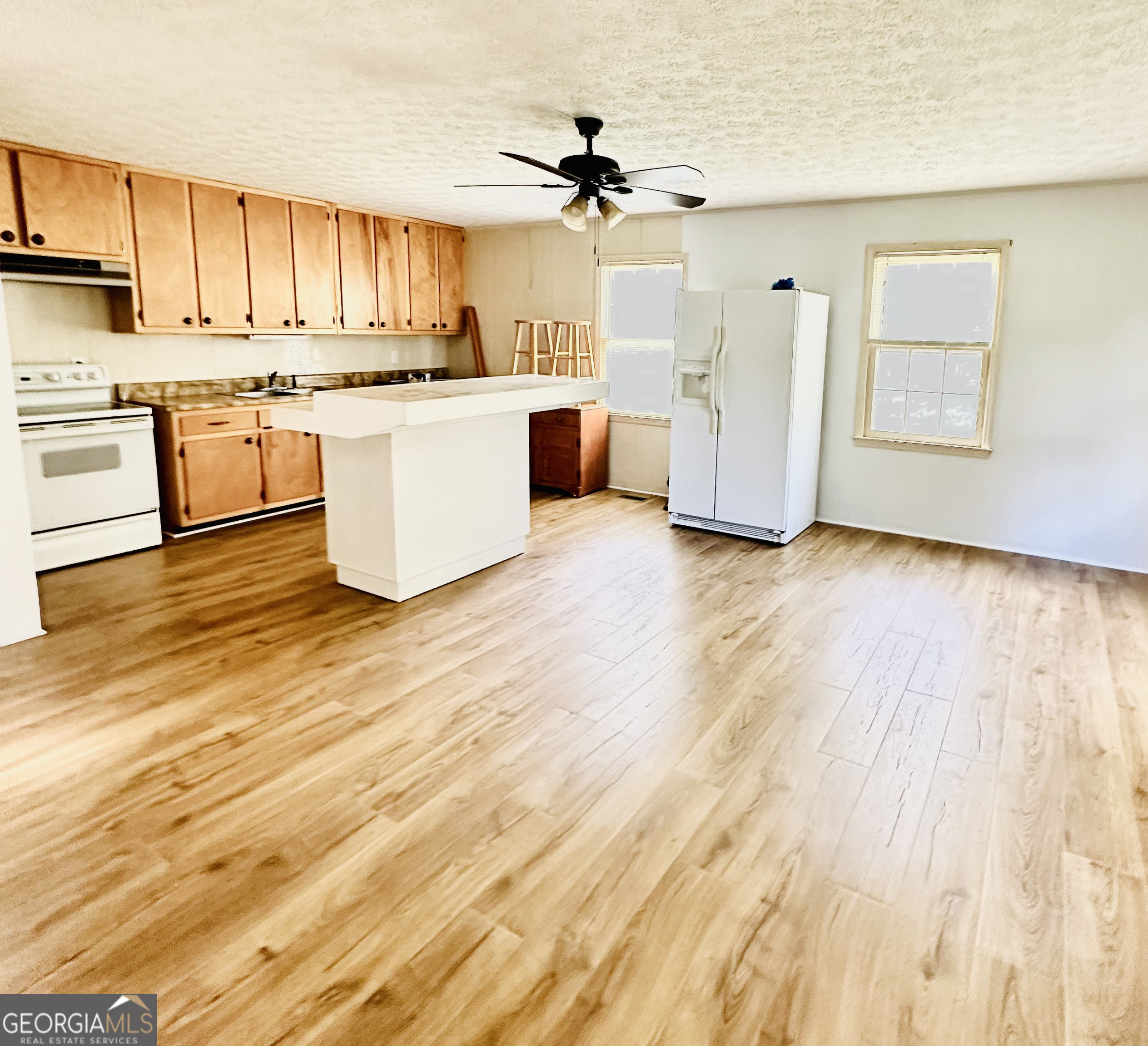 a kitchen with stainless steel appliances a stove top oven and a refrigerator