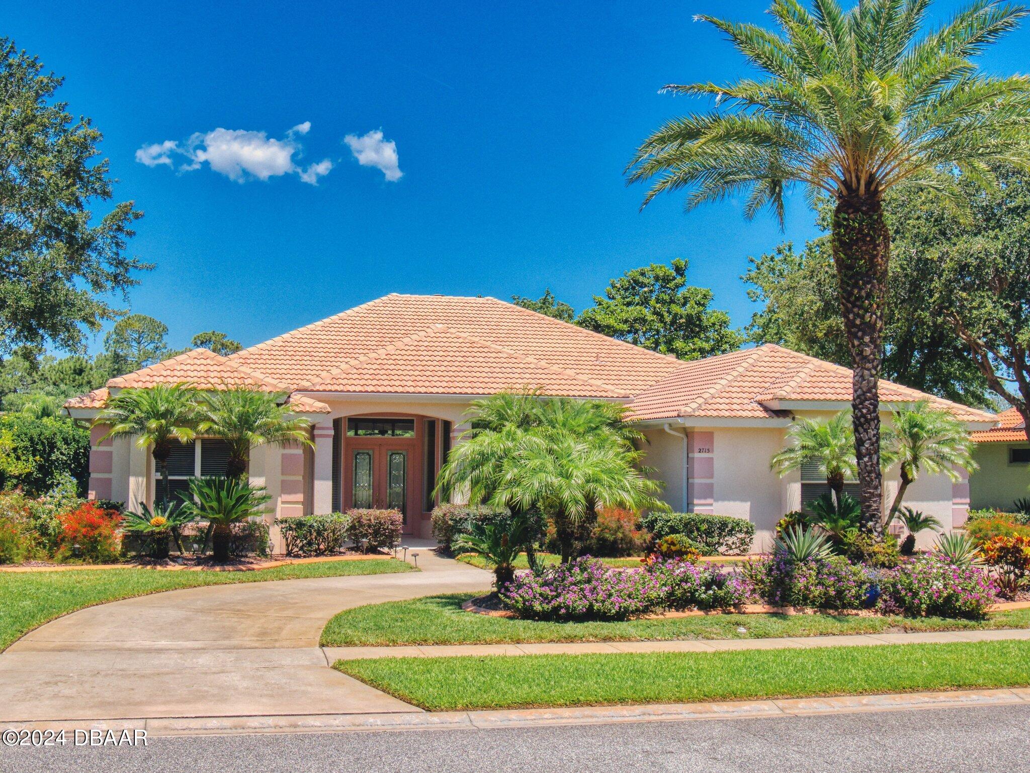 a front view of a house with a garden