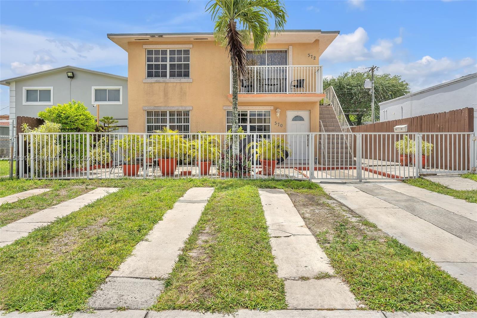 a view of a house with a yard and plants