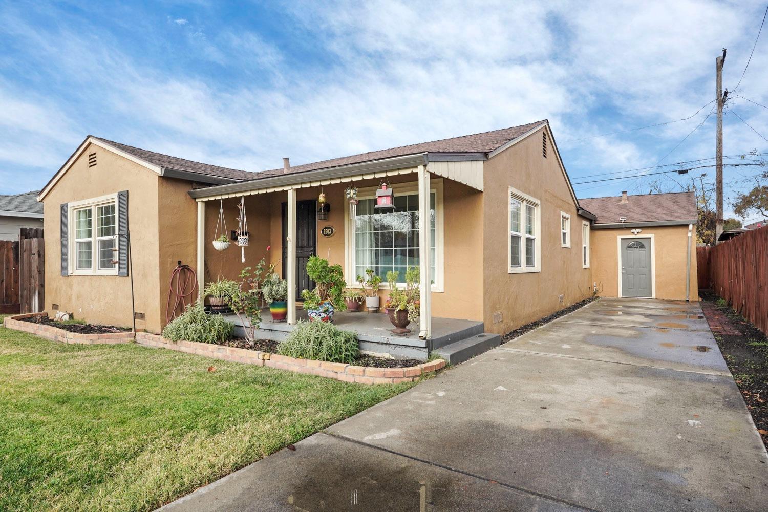 a front view of house with yard and outdoor seating