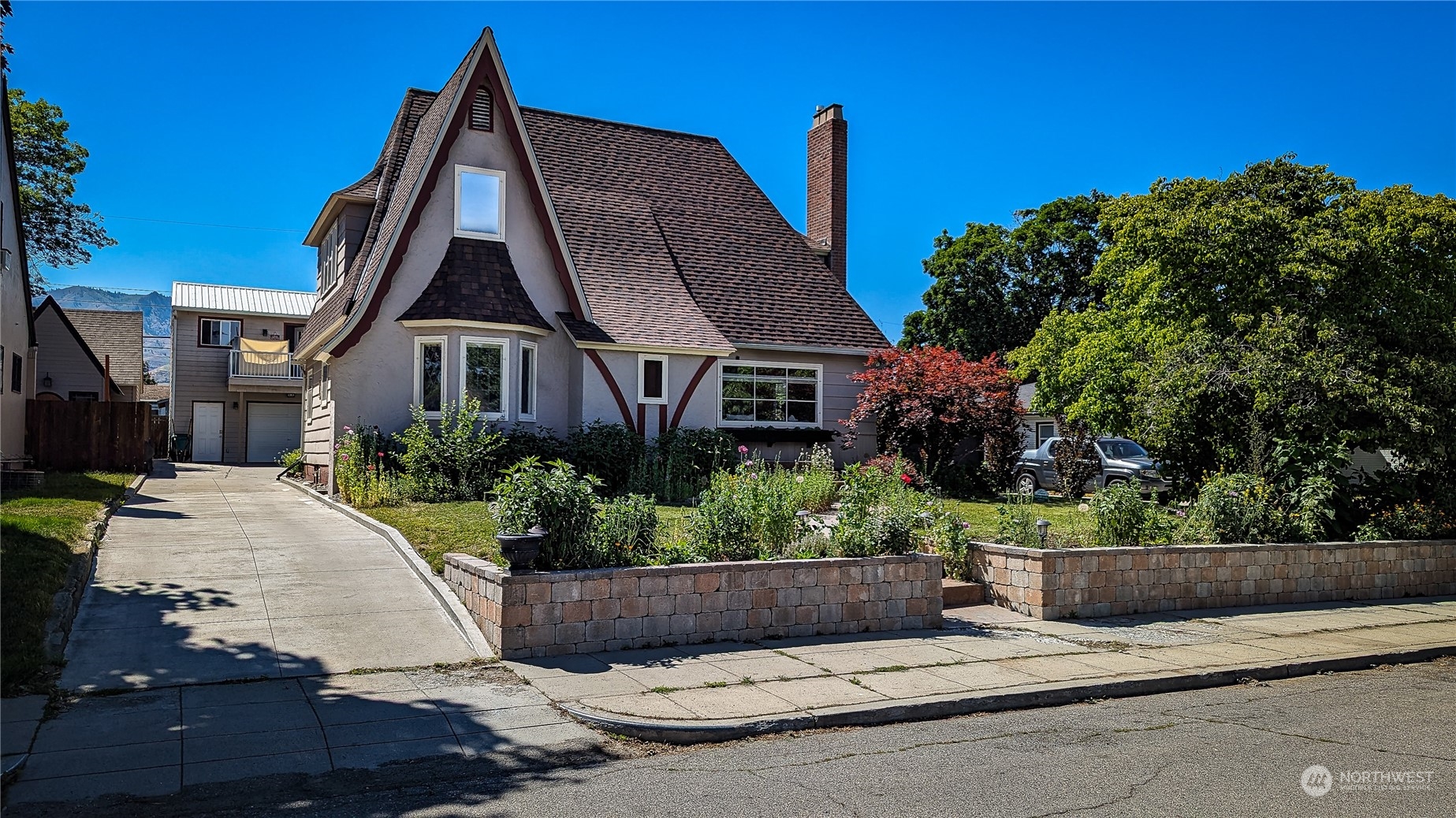 a front view of a house with a garden