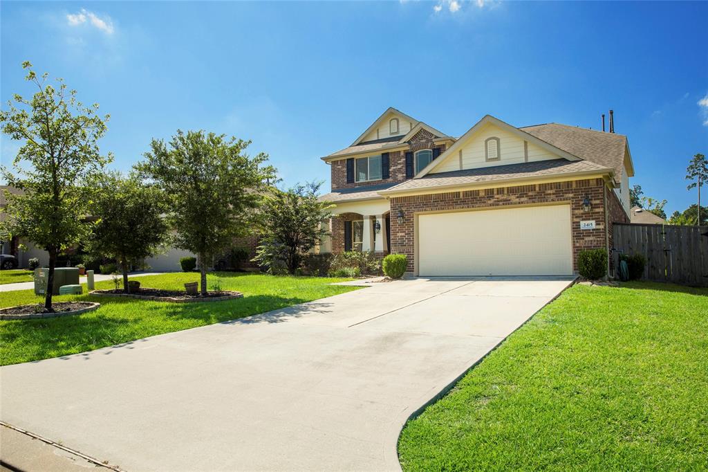 a front view of a house with a yard and garage