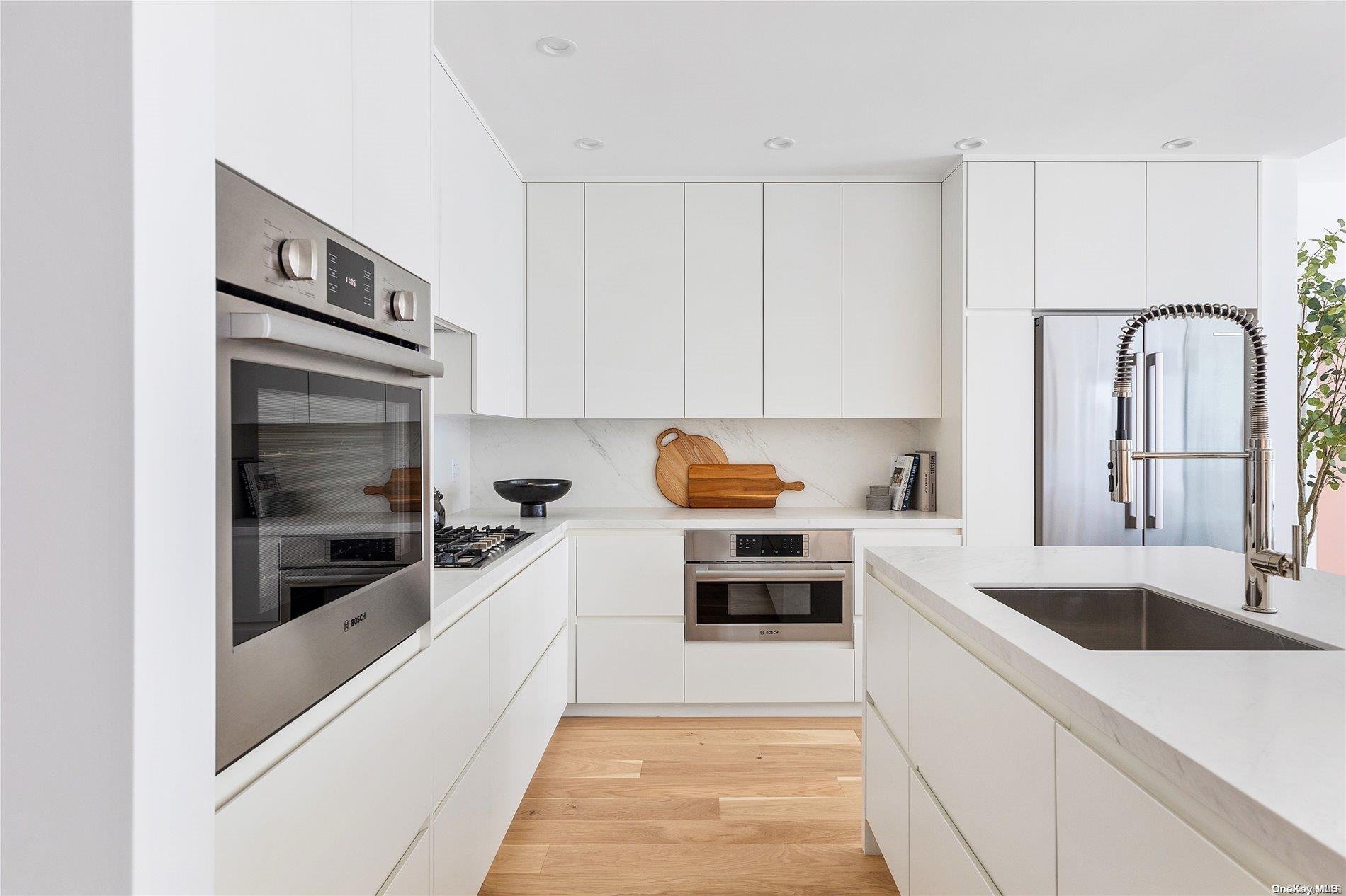 a kitchen with granite countertop a refrigerator and a sink