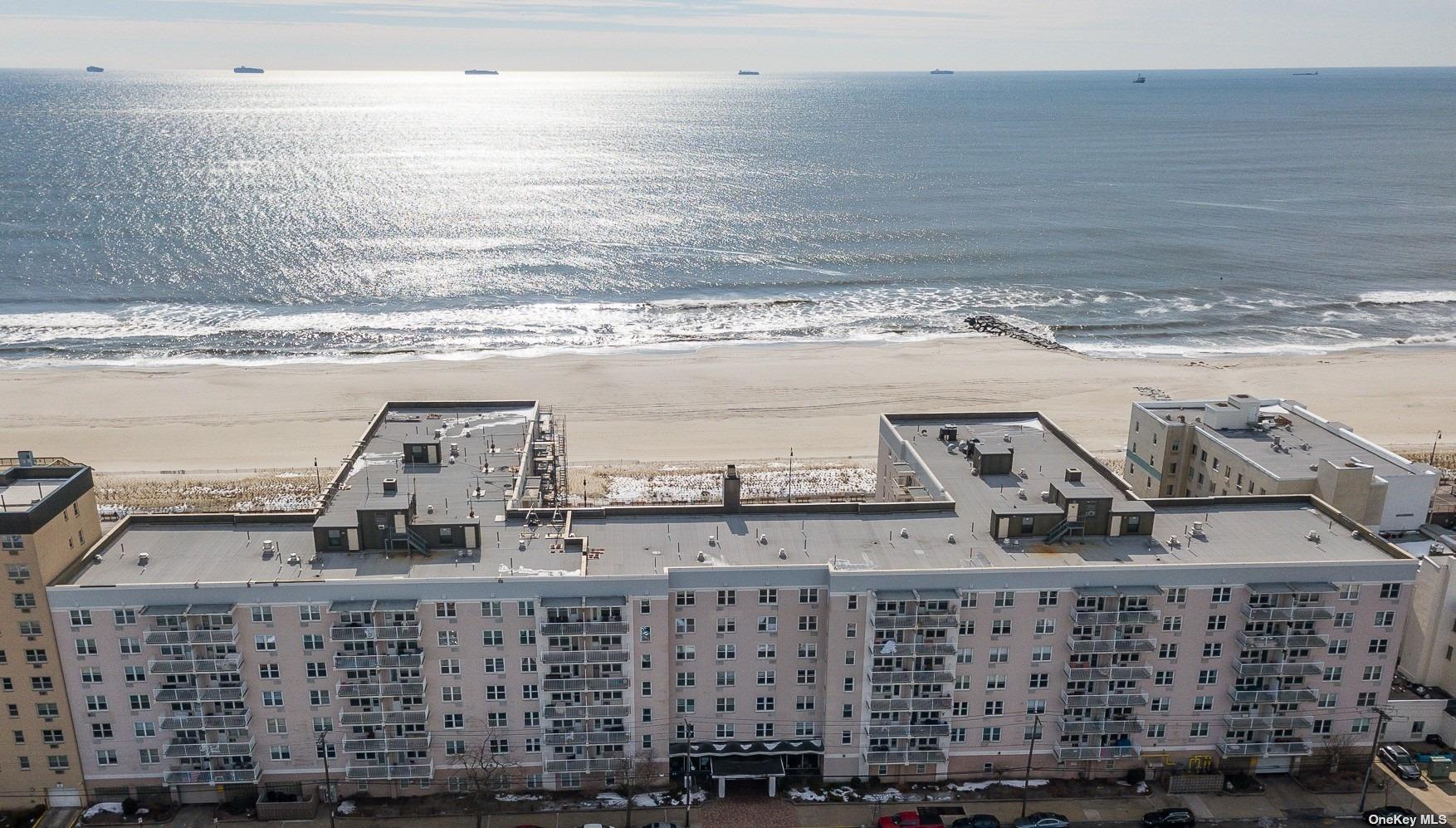 a view of ocean with large building