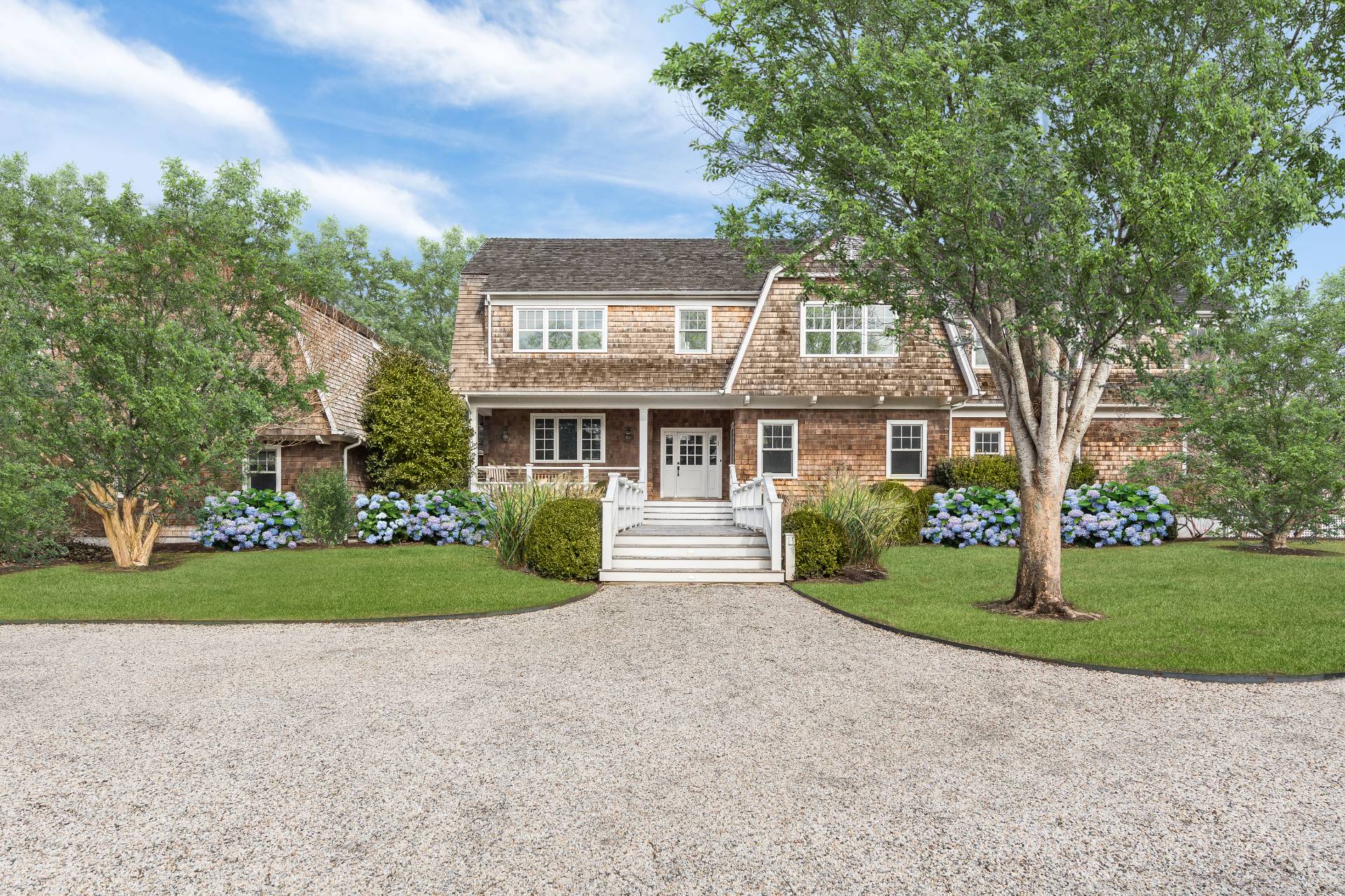 a front view of a house with a garden and pathway