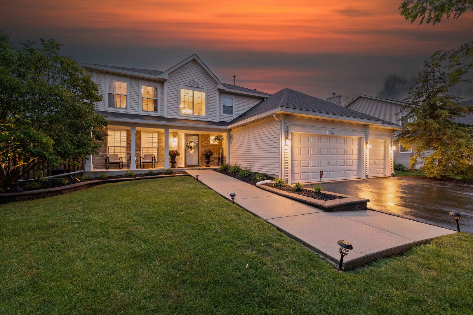 a view of a house with backyard and sitting area