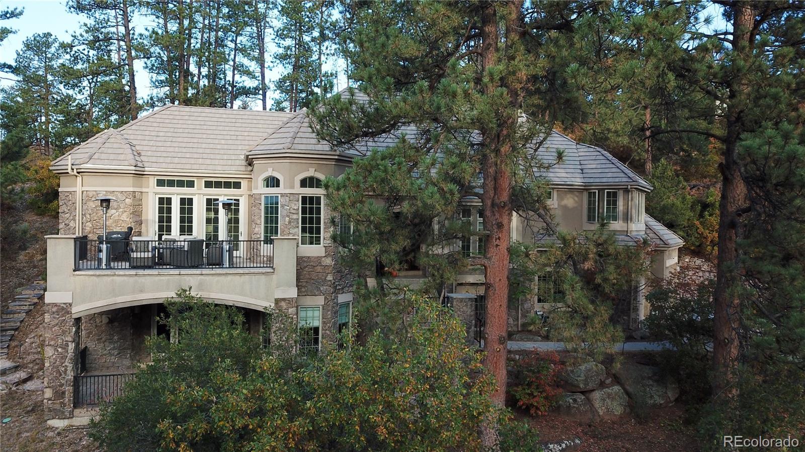 a aerial view of a house with yard and tree s