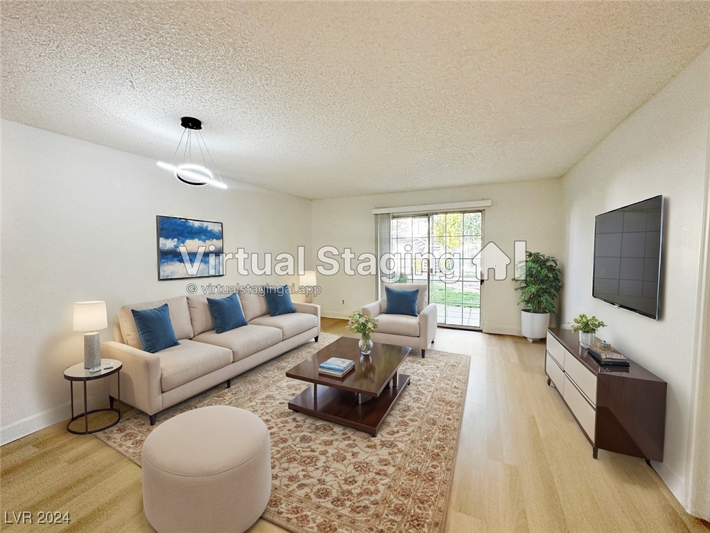 Living room with baseboards, light wood-style floo