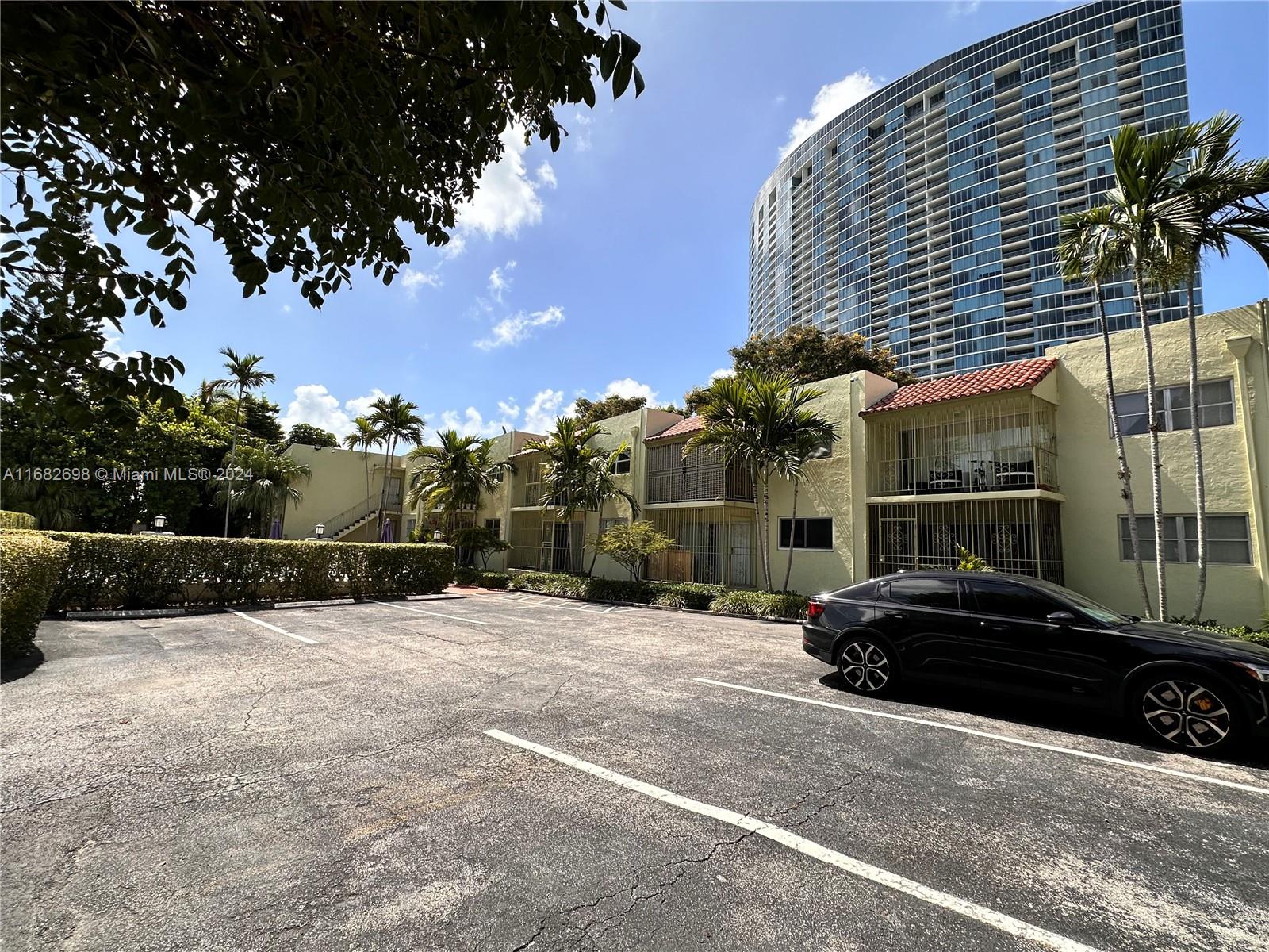 a view of a street with a car parked in front of it