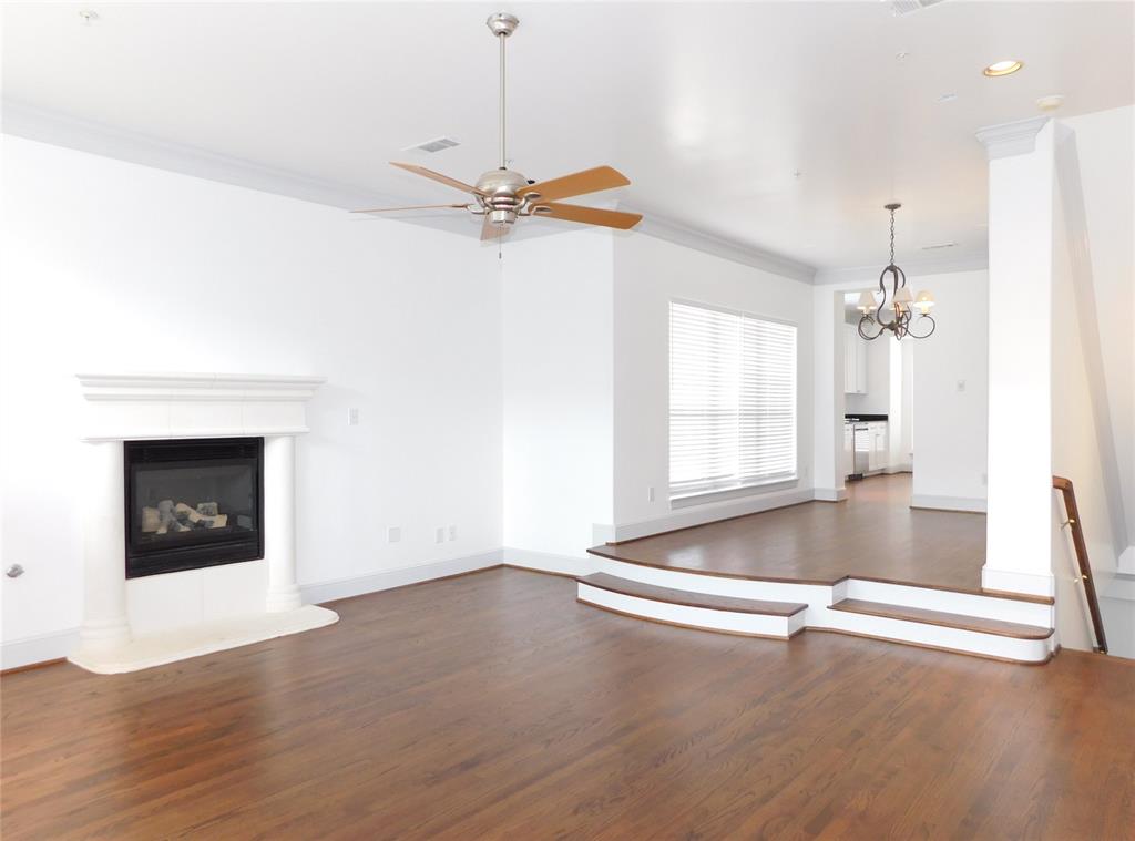 a view of an empty room with a fireplace and a window