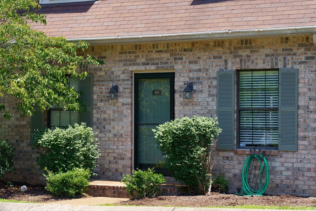 a front view of a house with plants