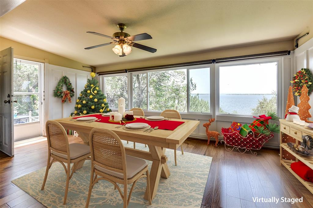 a dining room with furniture window and wooden floor