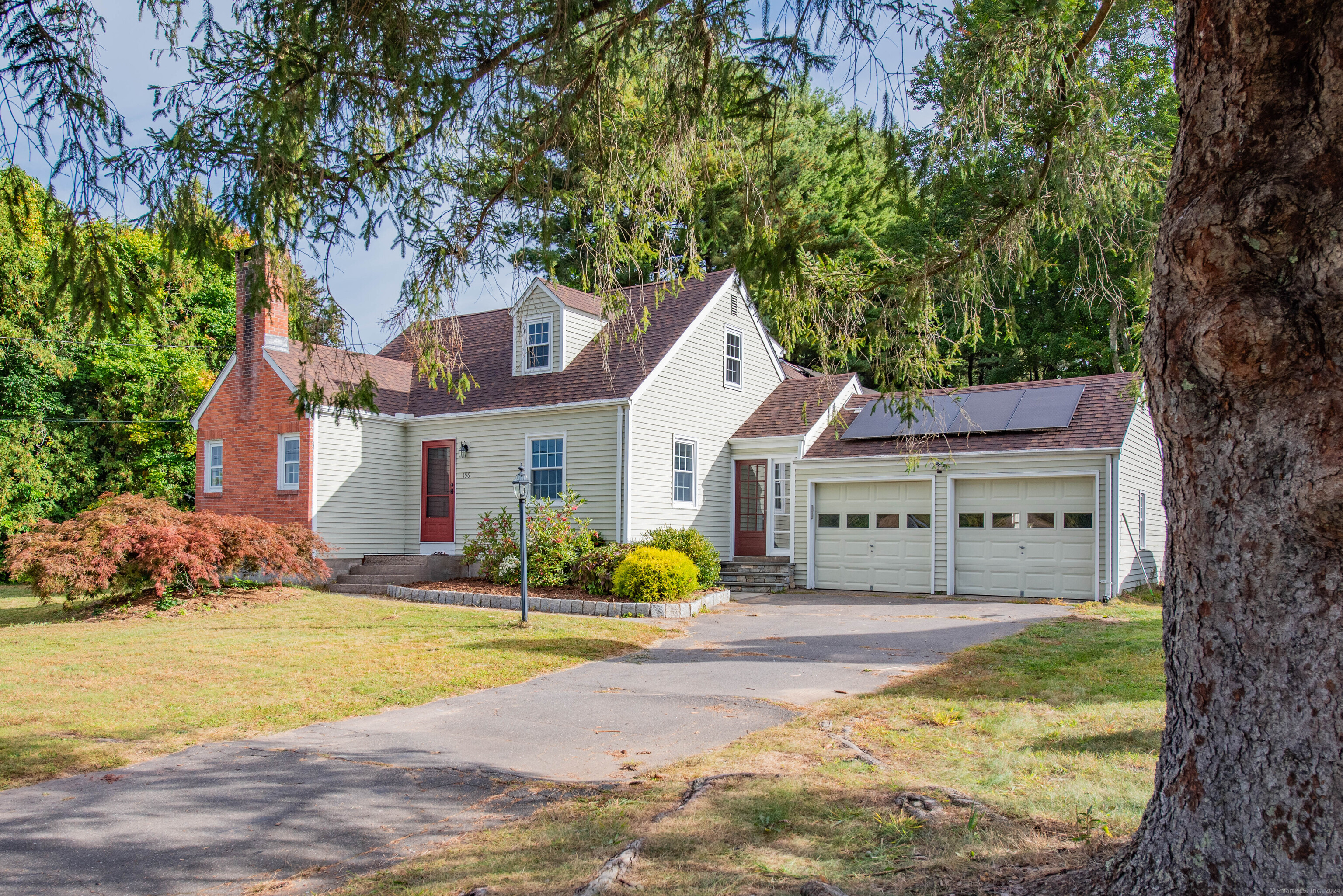 a front view of a house with swimming pool and porch