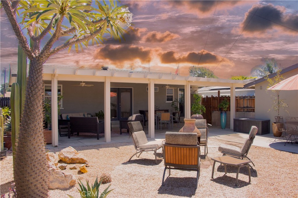 a view of a patio with a table and chairs under an umbrella