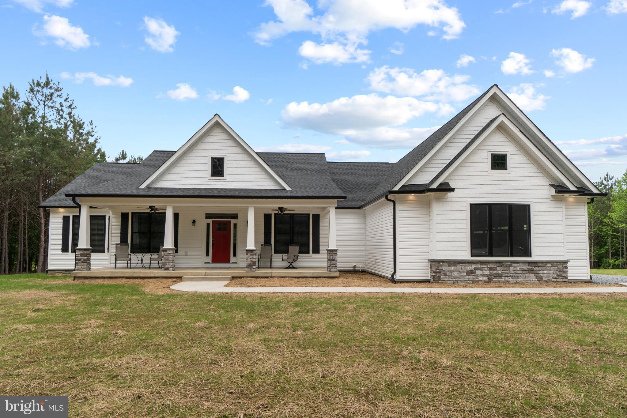 a front view of house with yard outdoor seating and barbeque oven