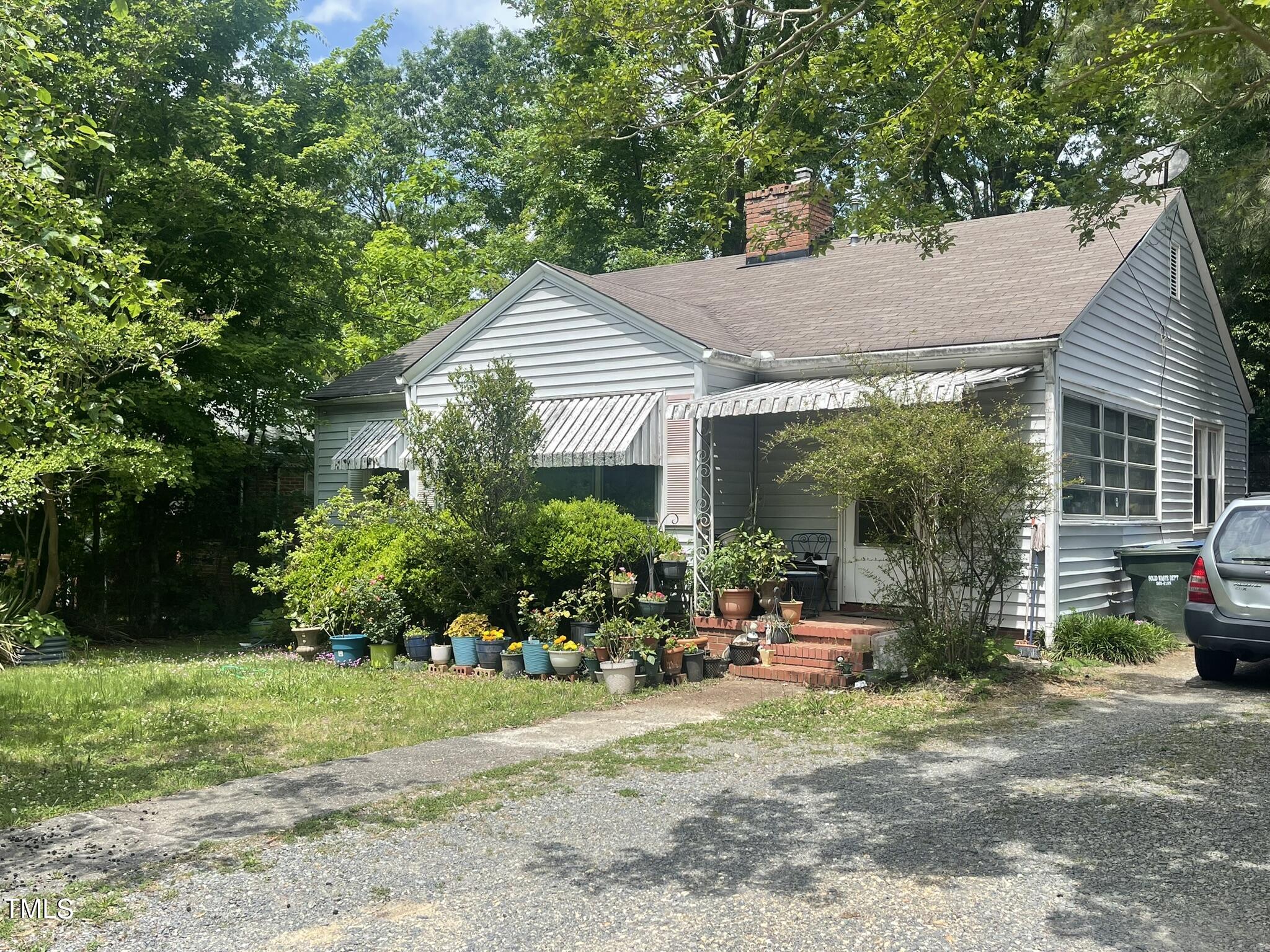 a backyard of a house with a garden and plants