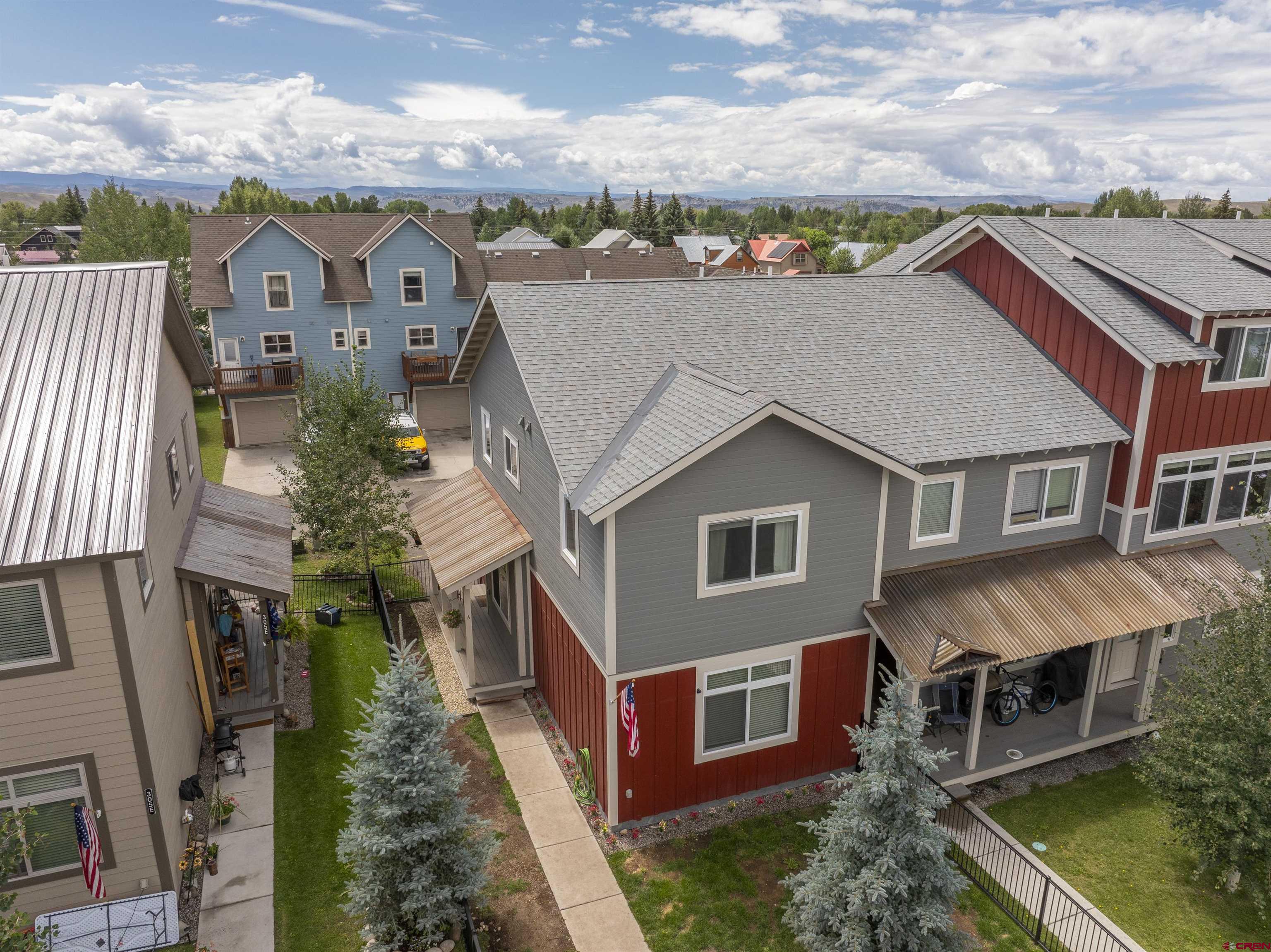 an aerial view of a house with a yard