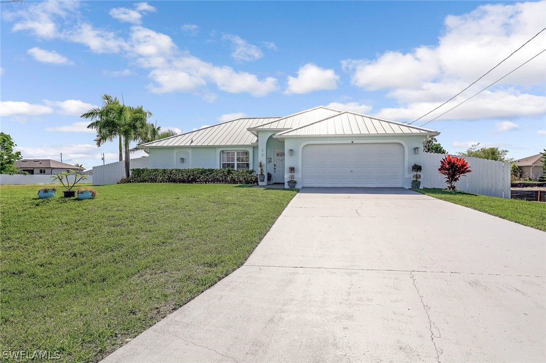 a view of a house with a yard and garage