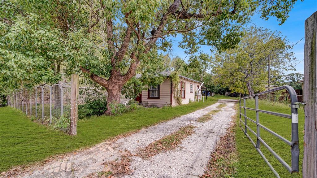 a front view of a house with a yard and an trees