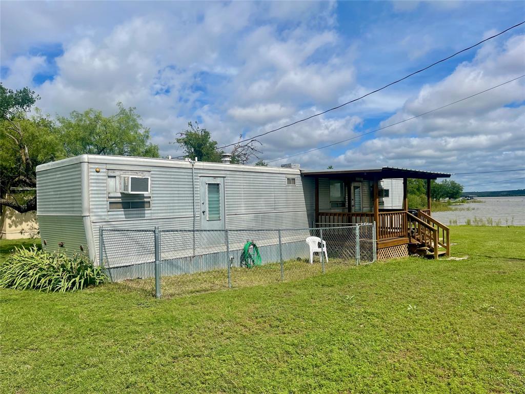 a view of house with backyard and garden