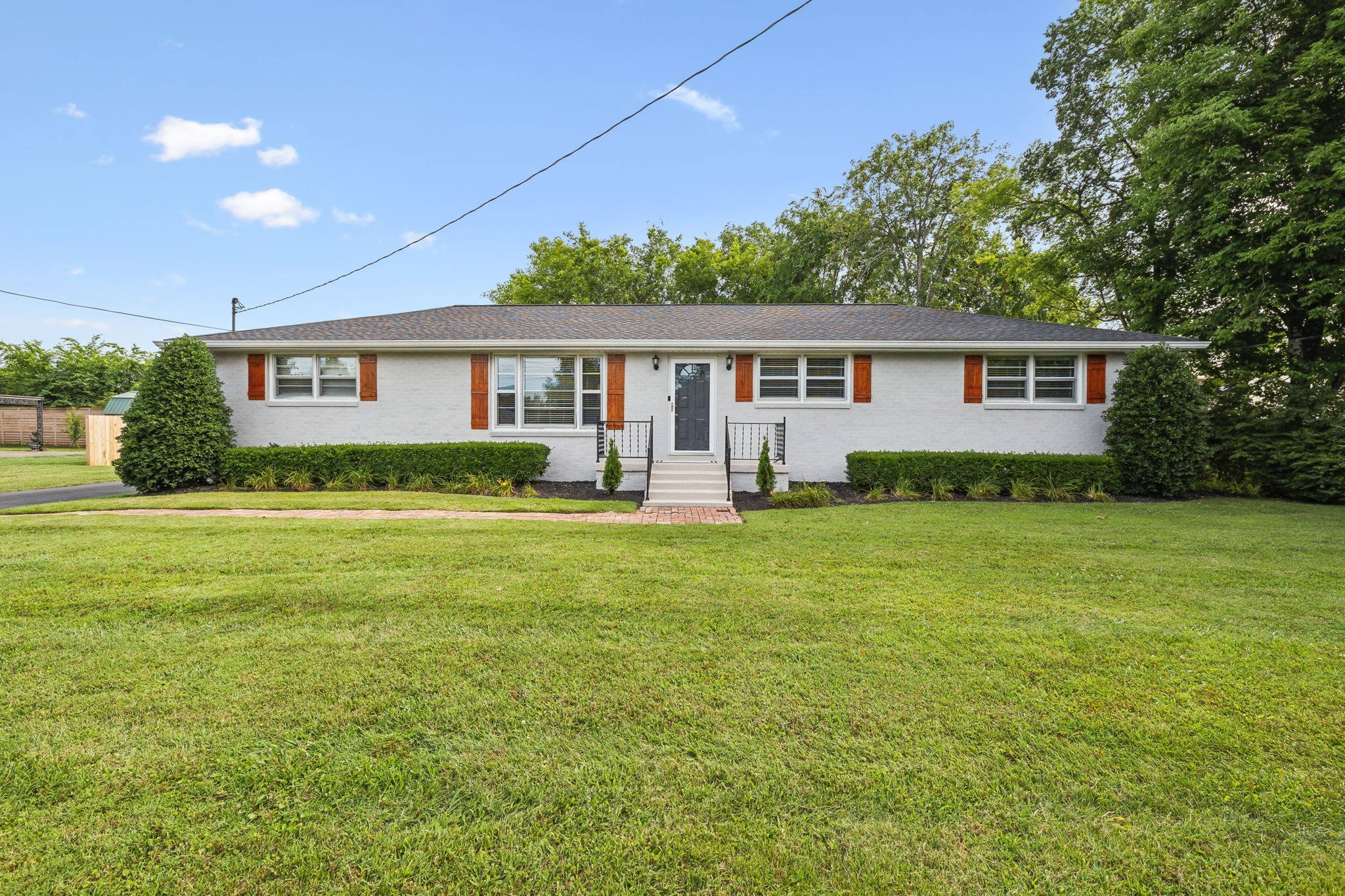 a front view of house with yard and green space