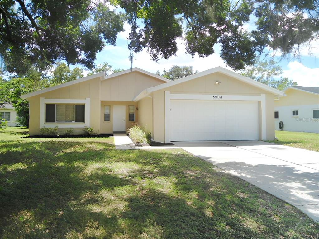 a front view of a house with a garden and yard