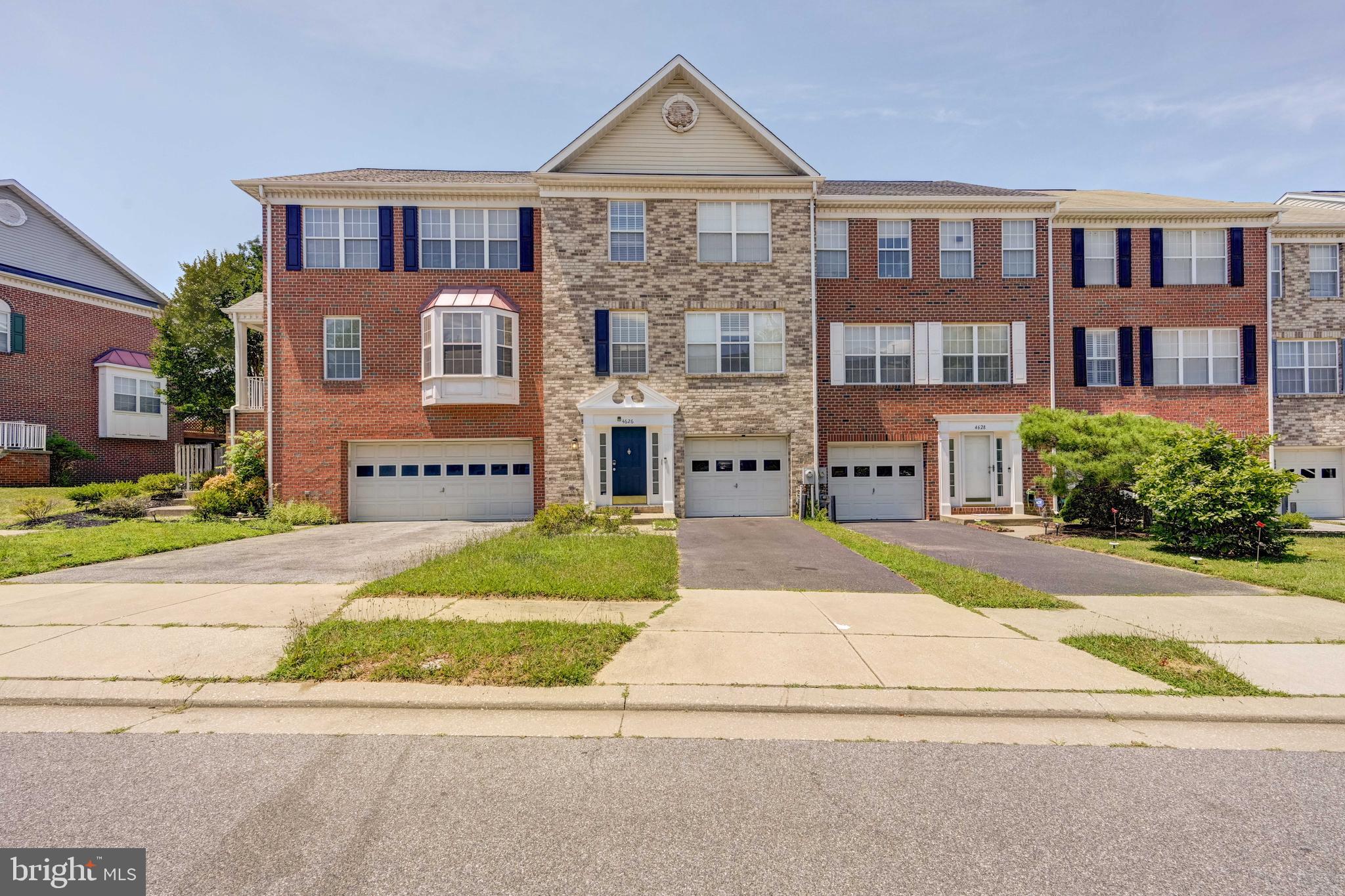 a front view of a brick house with a yard