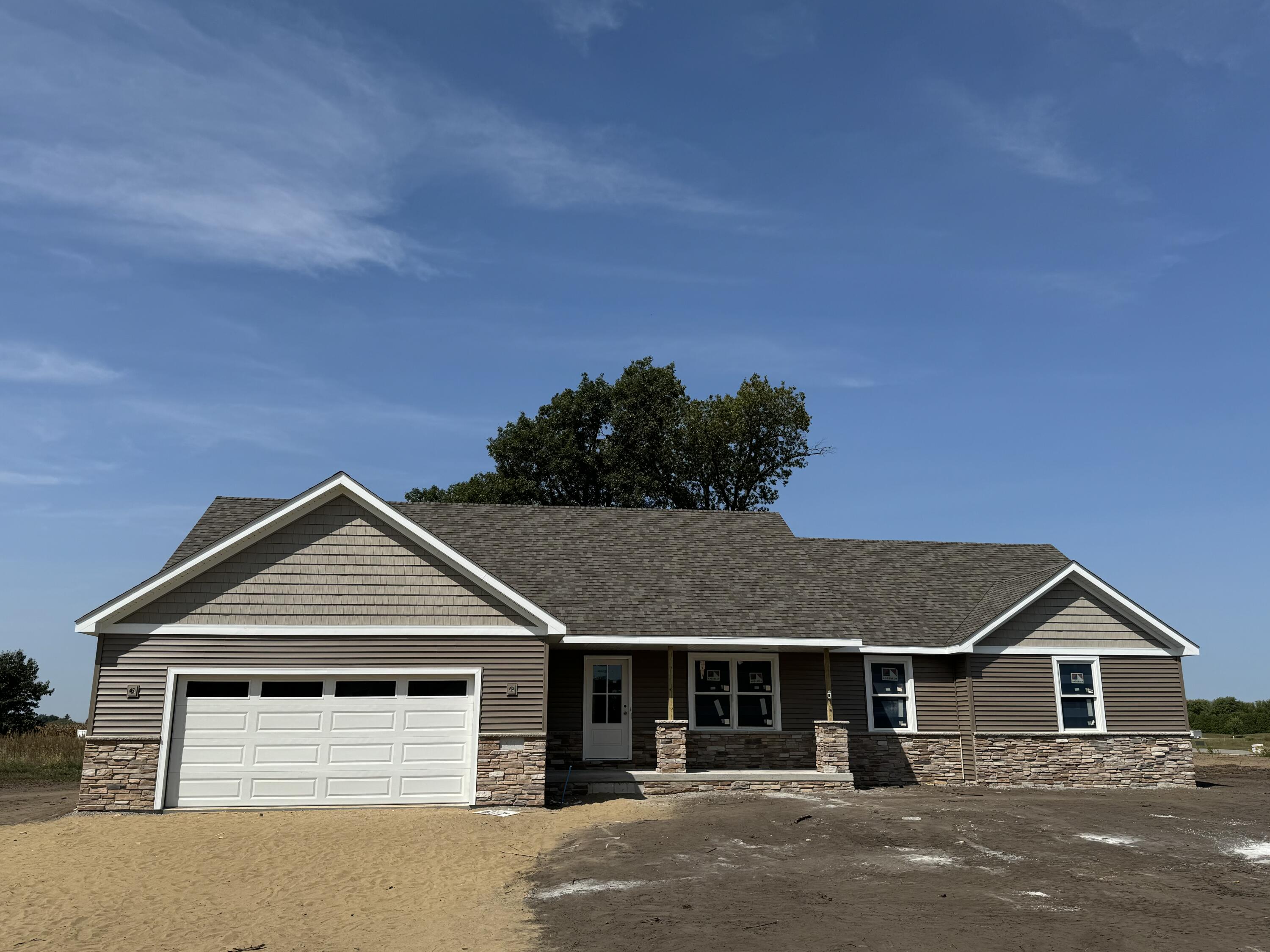 a view of a house with a yard and large parking space