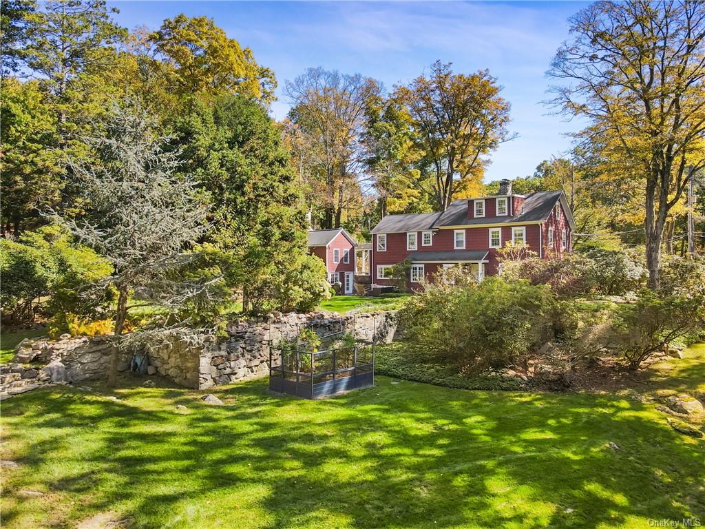 a backyard of a house with lots of green space and fountain