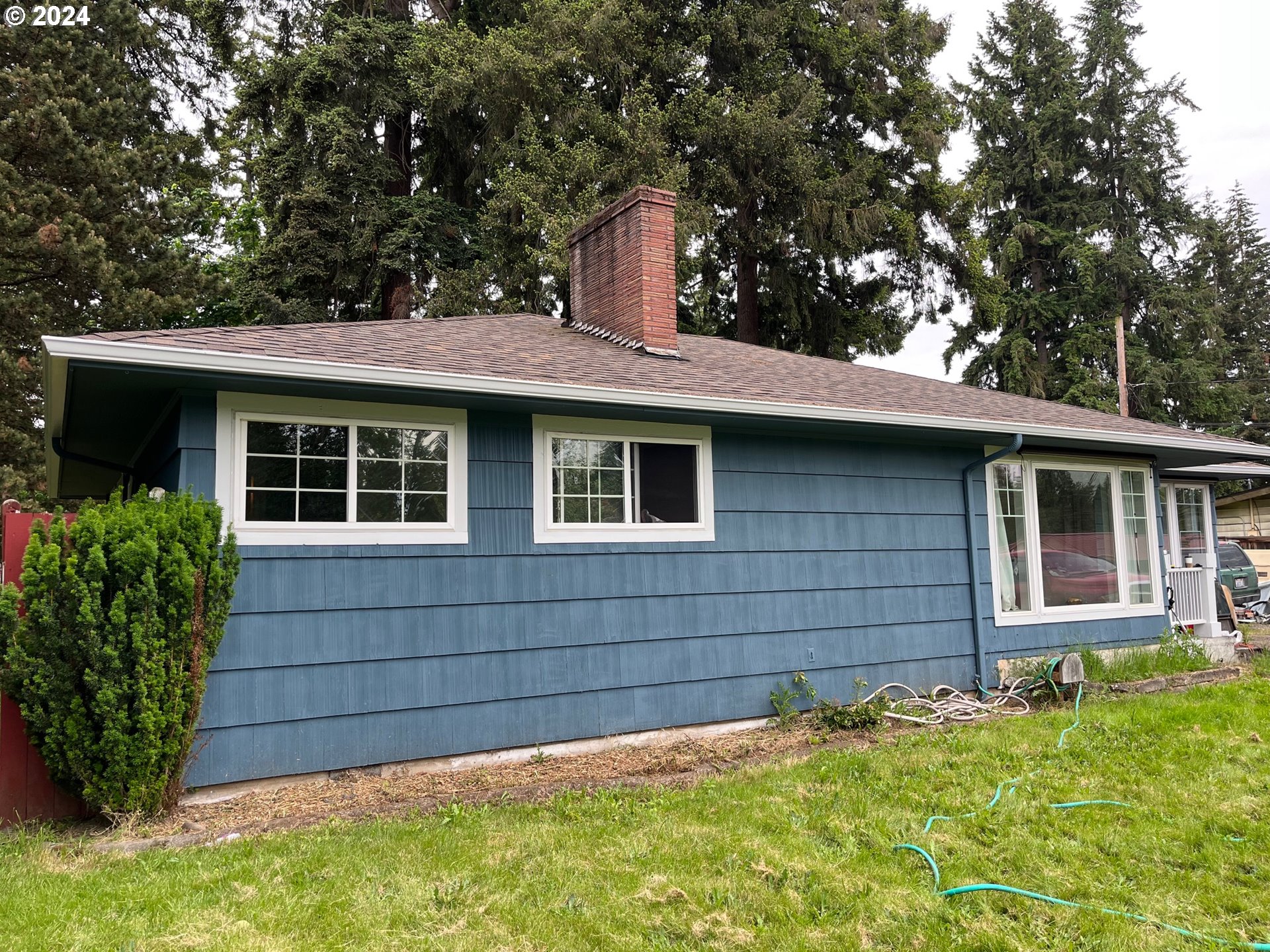 a front view of a house with a garden