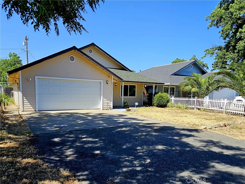 a front view of a house with a garden and yard