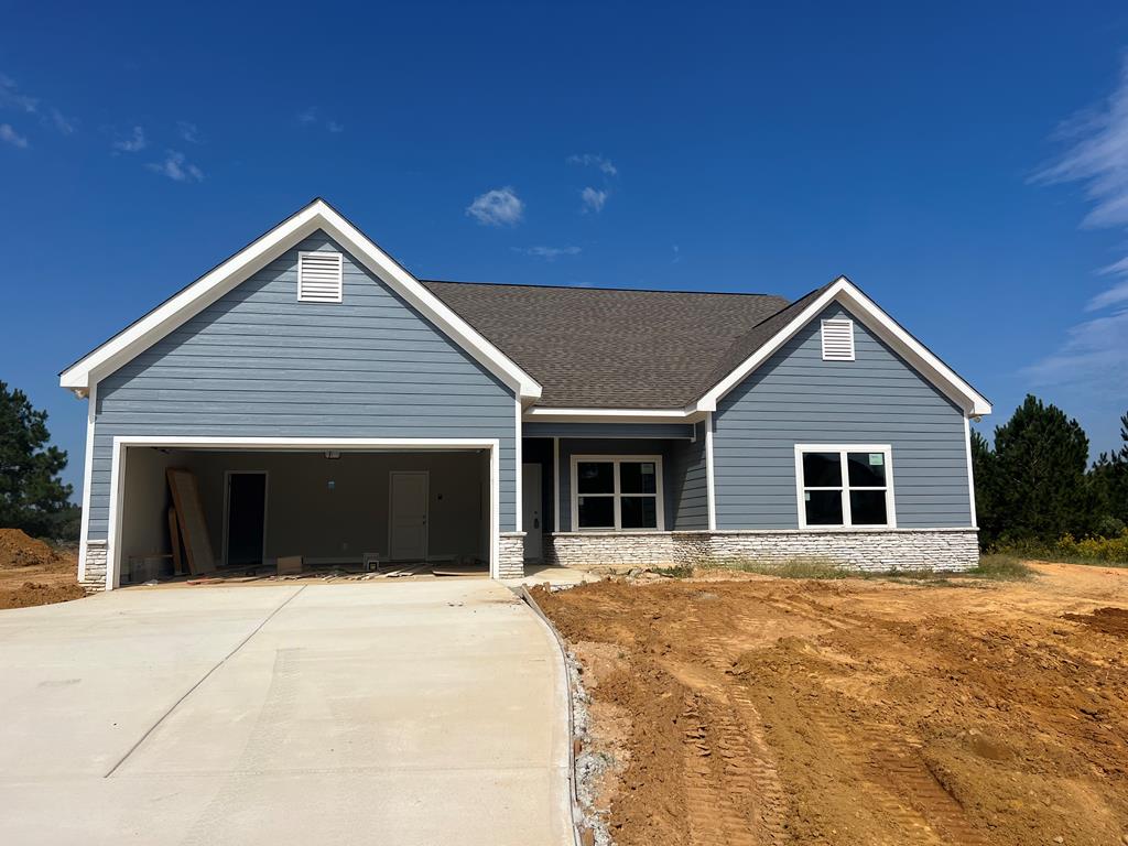 a front view of house with yard and garage