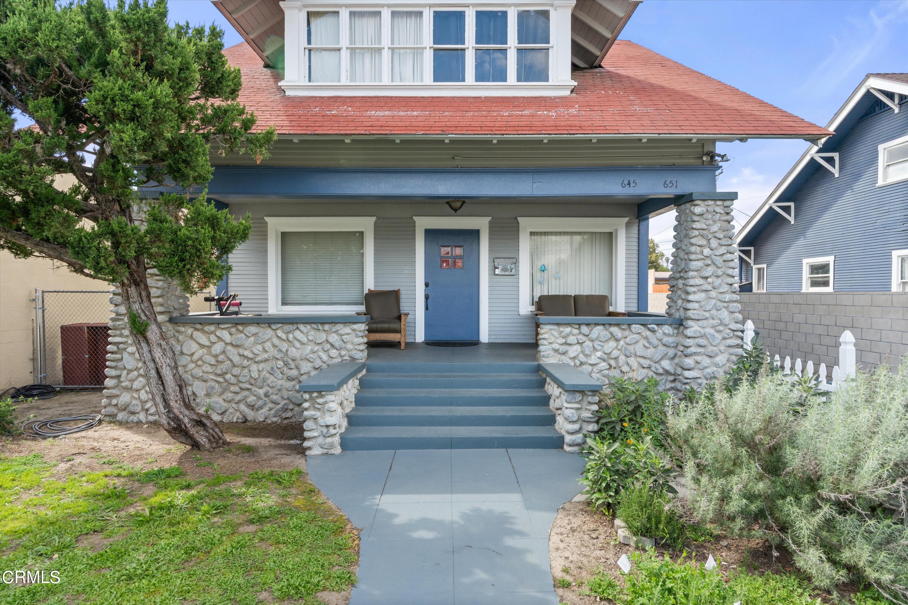 a front view of a house with a garden