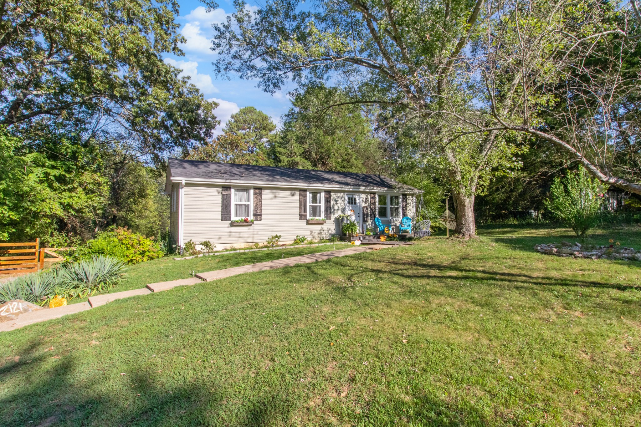 a view of a house with a yard and sitting area