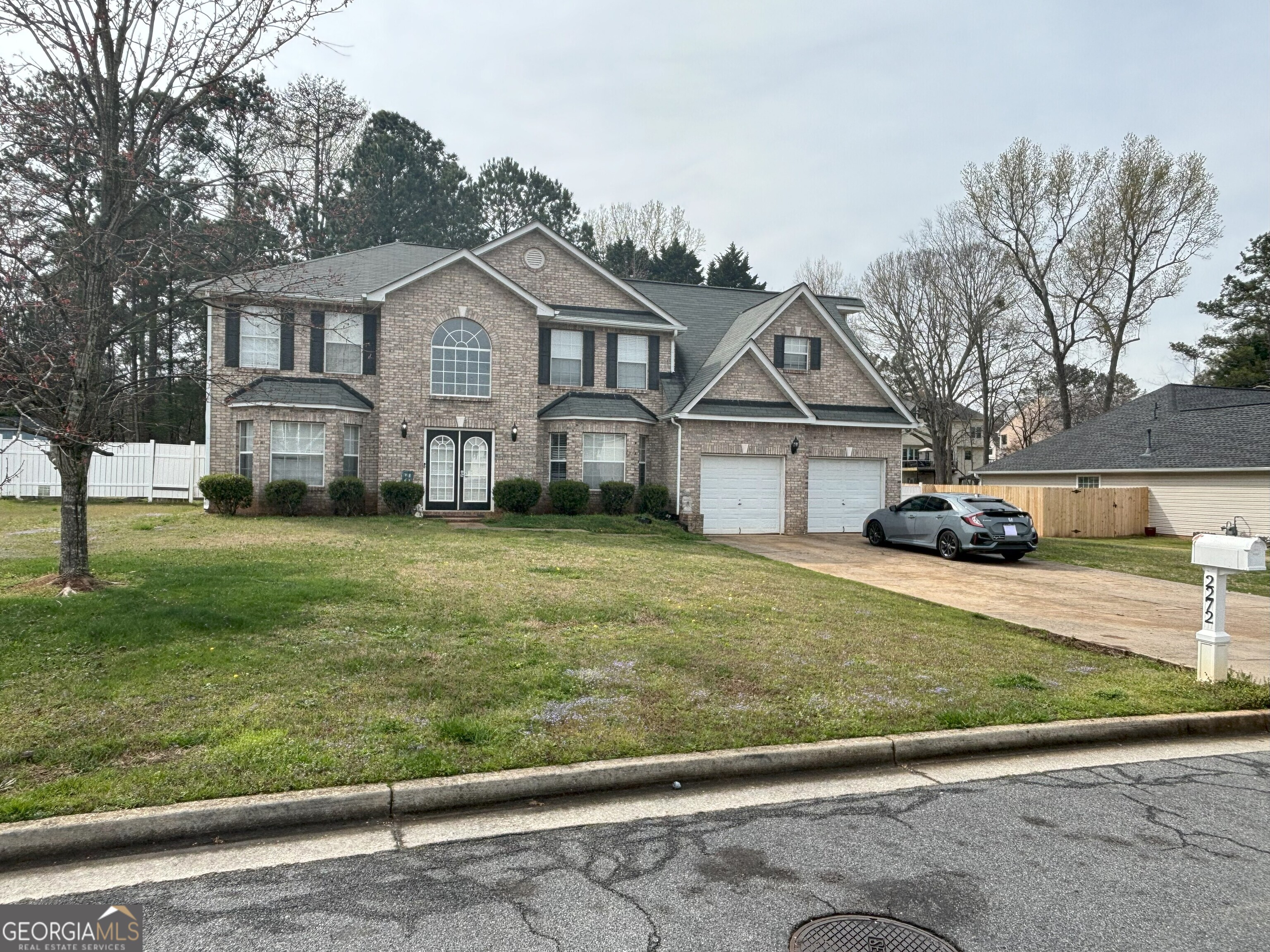 a front view of a house with a yard