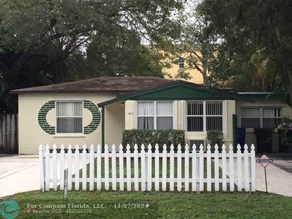 a front view of house with wooden fence