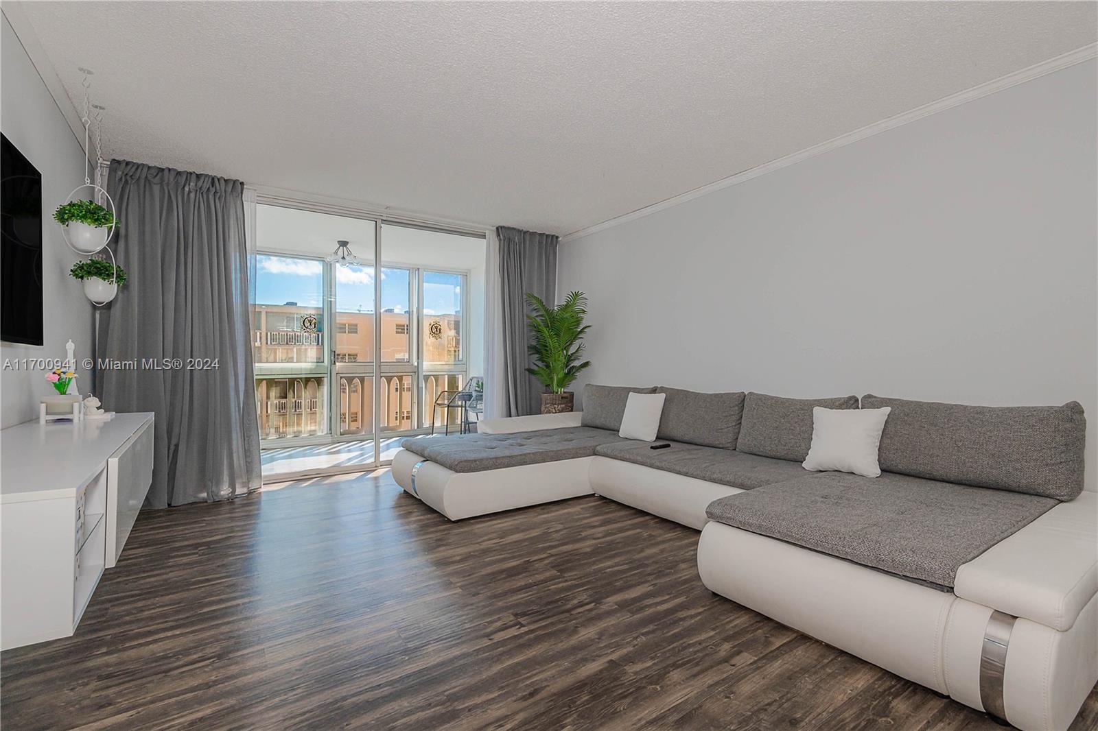 a living room with furniture and a large window