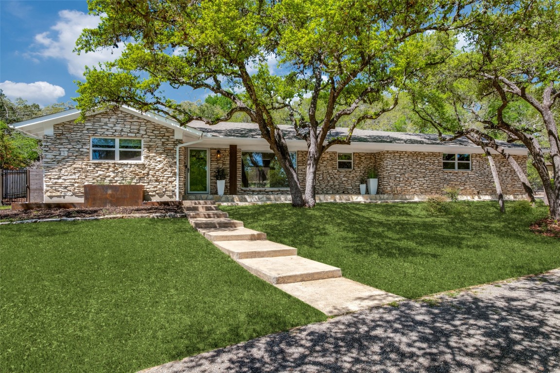 a front view of house with yard and green space