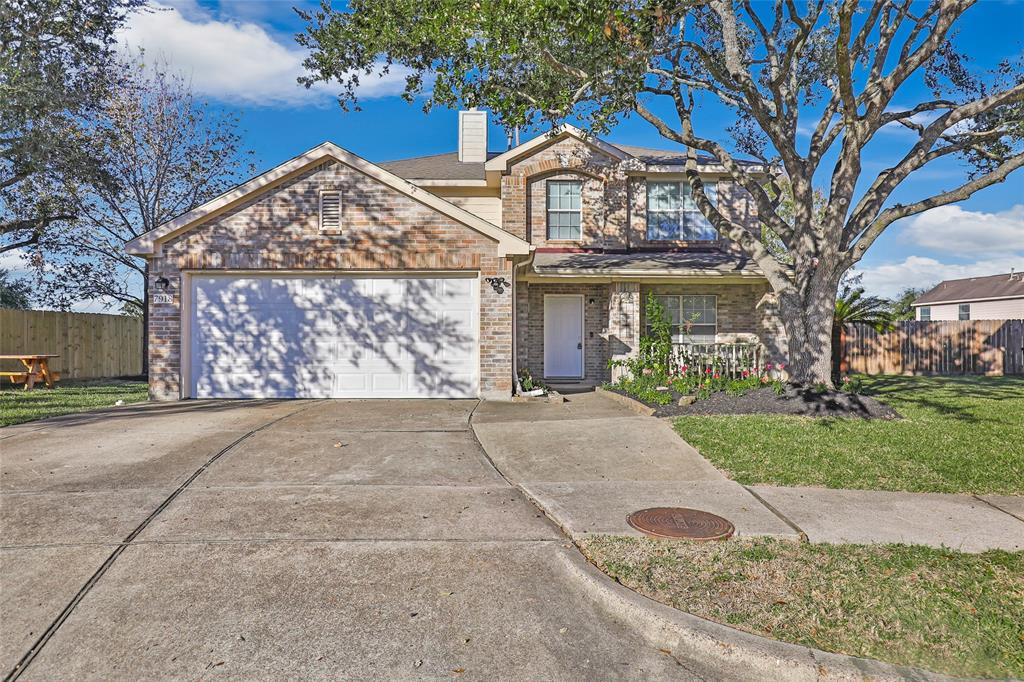 front view of a house with a yard and an trees