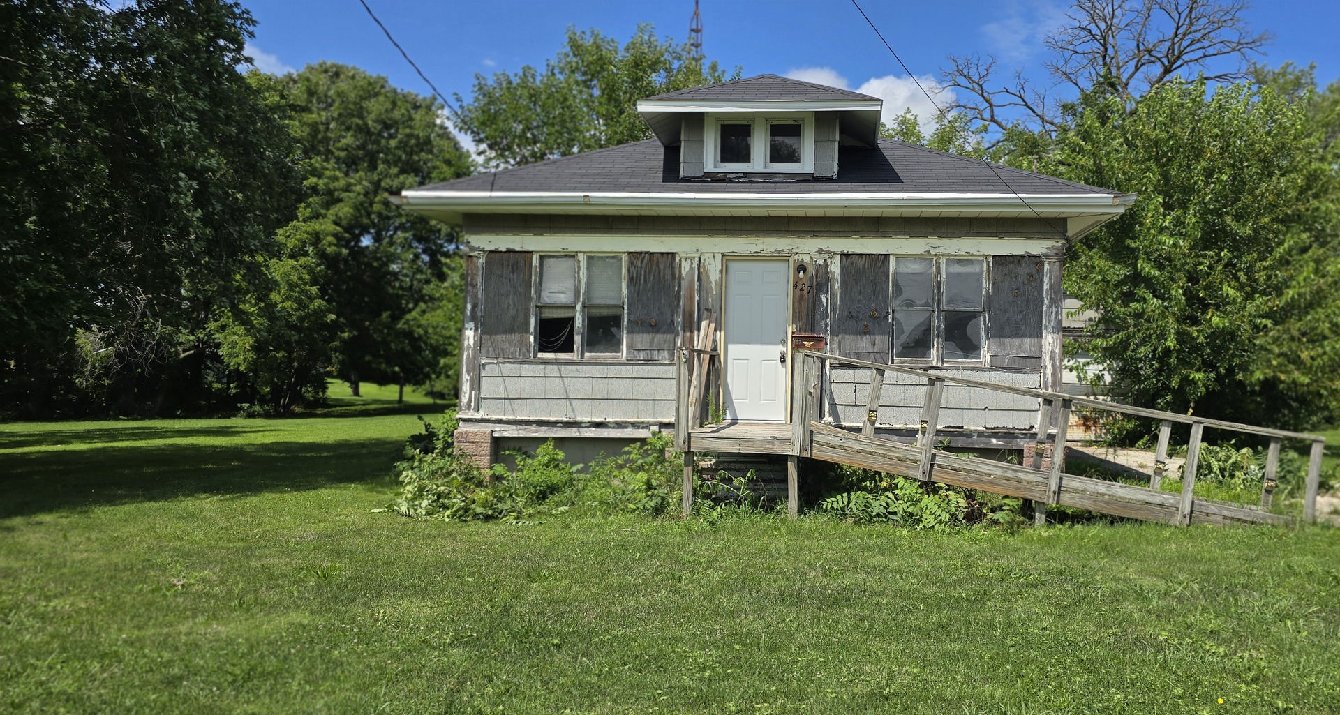 a front view of a house with a yard table and chairs