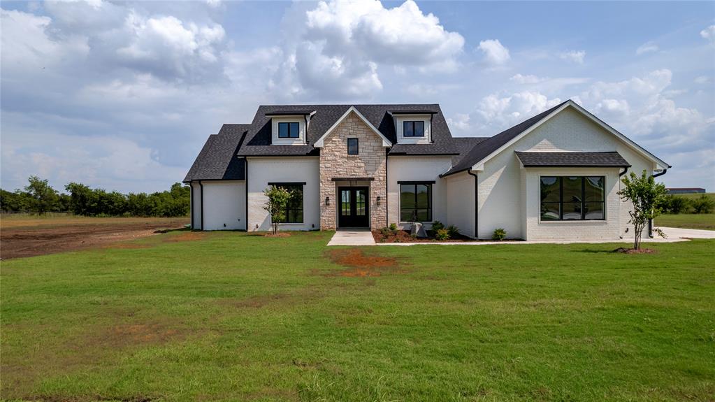 a front view of house with yard and green space