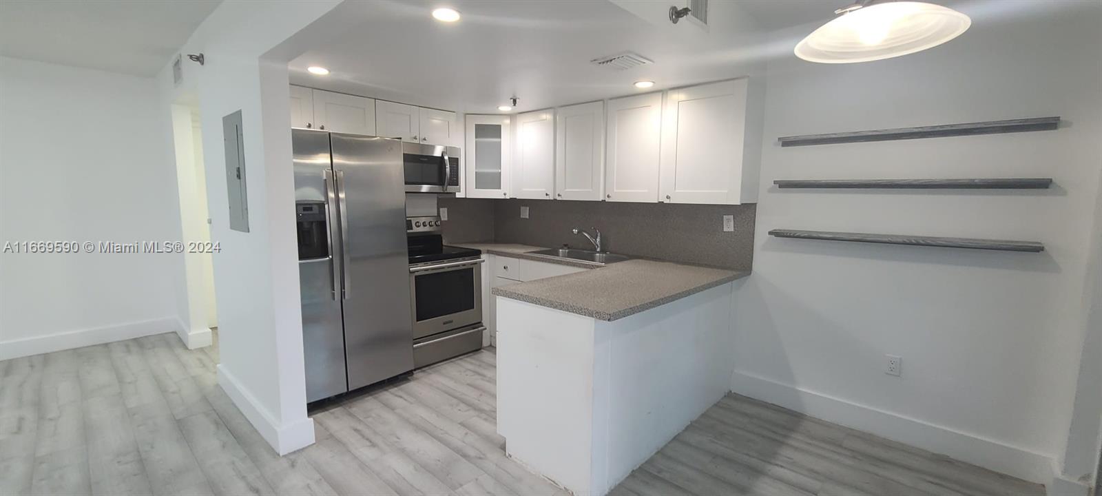 a kitchen with a refrigerator and a sink