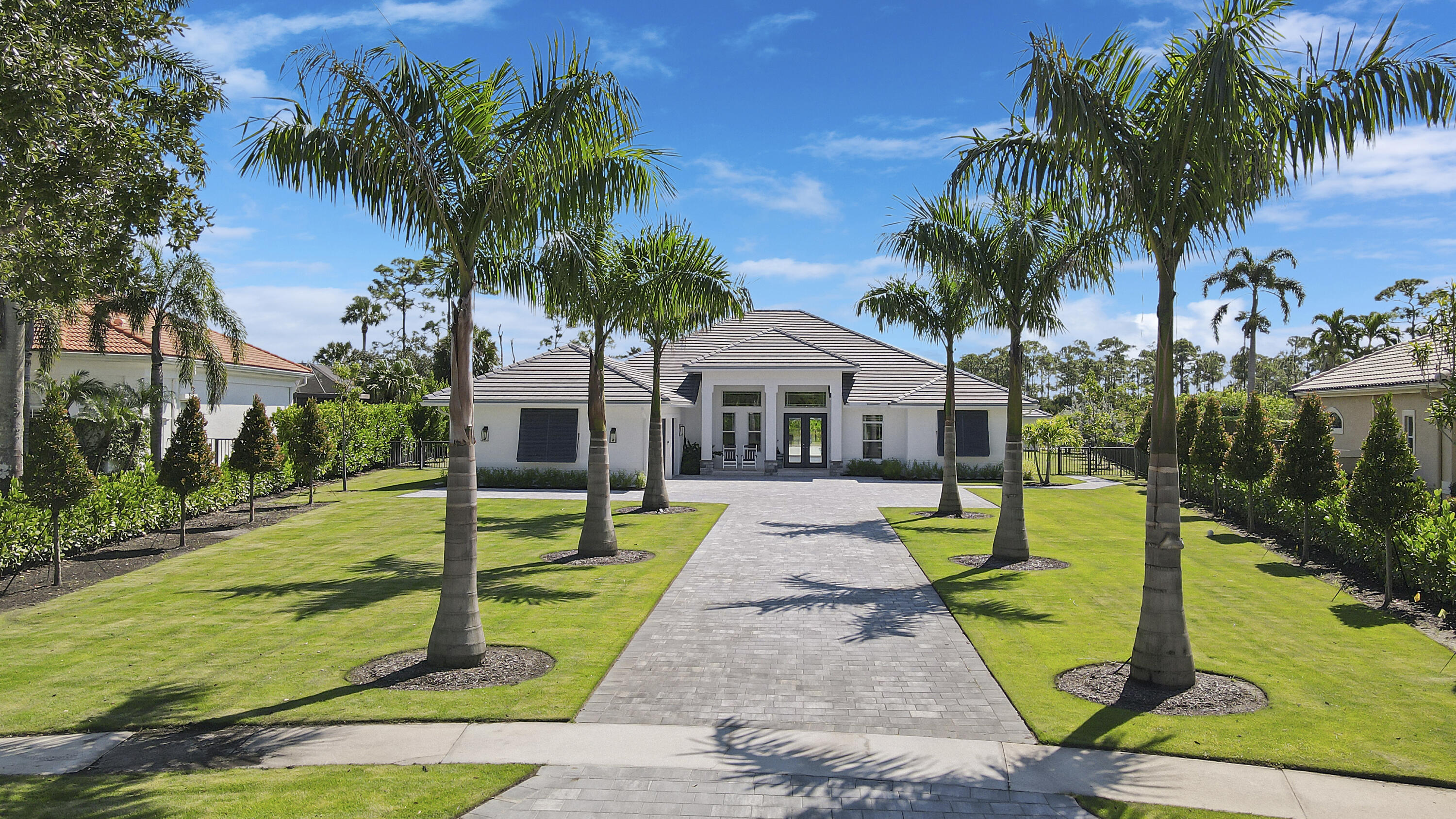 a front view of house with yard and green space