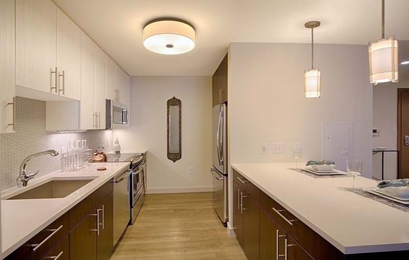 a kitchen with a sink stove and refrigerator